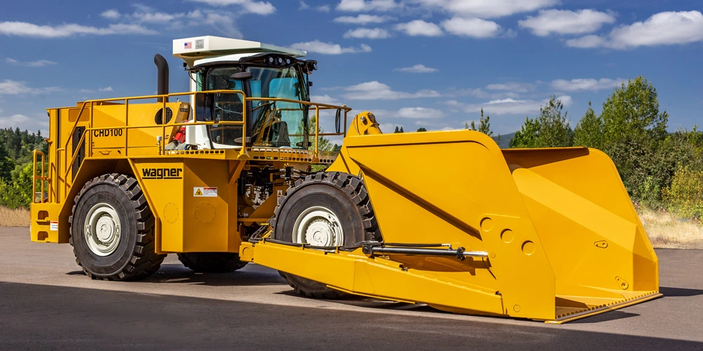 Yellow Wagner Chipdozer parked on pavement