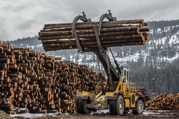 Yellow 4WD Wagner Logstacker parked with a raised load of logs