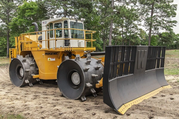 Yellow Wagner Landfill Compactor parked on level ground