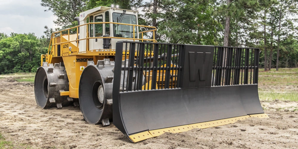 Yellow Wagner Landfill Compactor parked on level ground